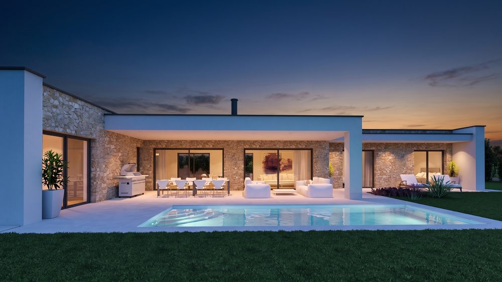 Cinematic blue-hour result of the villa garden facade with lit pool